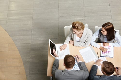 HR employees gathering around a computer