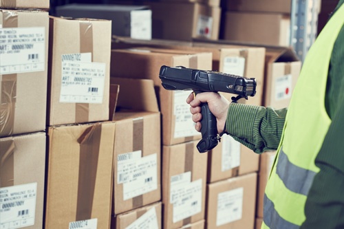 Image of someone scanning barcodes in a manufacturing warehouse