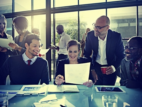 coworkers at a business meeting and smiling about CRM